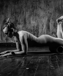 Person in a yoga pose on a mat with a textured wall background
