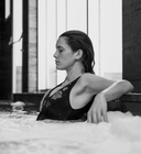 Woman relaxing in a hot tub with a scenic view outside